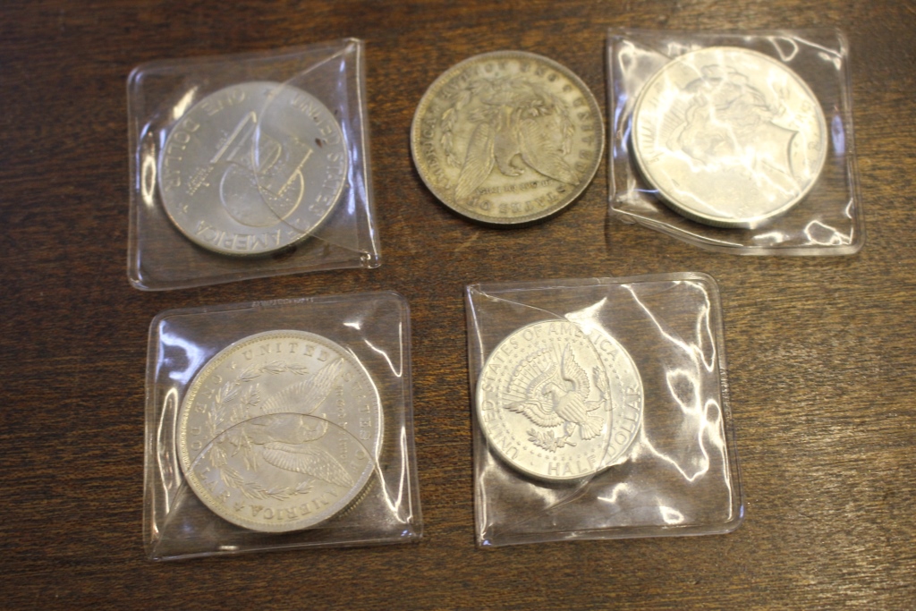 A collection of five U.S.A. silver dollars