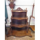 A Victorian walnut corner whatnot, the shaped four tiers on barleytwist supports 116cm high, and