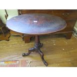 A George III mahogany snaptop tripod table, with oval top and turned tapering stem, 67cm wide