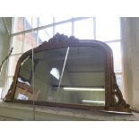 A Victorian giltwood overmantel mirror, with mask over an arched plate within an egg and scroll