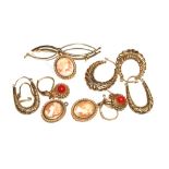 A collection of hoop and cameo earrings