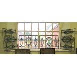 Four Edwardian stained glass lead glazed panels, with wreath designs, 38cm x 53cm
