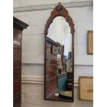A walnut framed full length wall mirror, the shaped top with shell carved motif, 105cm high