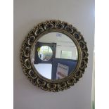 An oak framed wall mirror, with circular bevelled plate, 66cm square and a circular giltwood wall