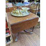 A George IV style mahogany dropleaf table, with ring turned stem on a reeded quadruped base with