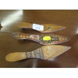 Two 19th century inlaid shoe form letter openers, and another with painted bird, 17cm x 19cm long (