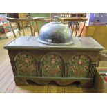 A Swiss style painted chest, the hinged lid over an arched front painted with vases of flowers,