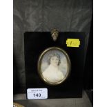 A watercolour miniature of an 18th century young gentleman within a black frame, 6.5cm x 5cm (oval)