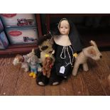 A Panda soft toy, a doll dressed as a nun and other soft toy animals