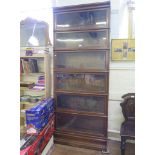 A stained oak Globe Wernicke style stacking bookcase, the six graduated shelves with glass fall