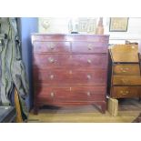 An early 19th century crossbanded mahogany chest of drawers with two short and three long