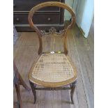 A Victorian walnut bedroom chair with scroll rail, cane seat and turned legs