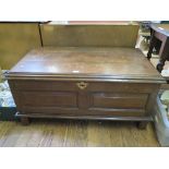 An oak blanket box, the hinged lid over a double panel front on stile feet 108cm wide