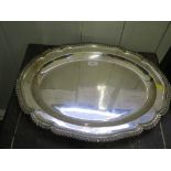 An oval silver plated tray with gadrooned edge