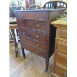 A George III mahogany cabinet, the hinged glass bijouterie top over a dummy drawer, four short and