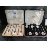 A set of six silver and enamel coffee spoons in presentation case and a box of six coffee spoons