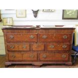 A George III oak and mahogany crossbanded mule chest, the hinged top over two dummy drawers, above