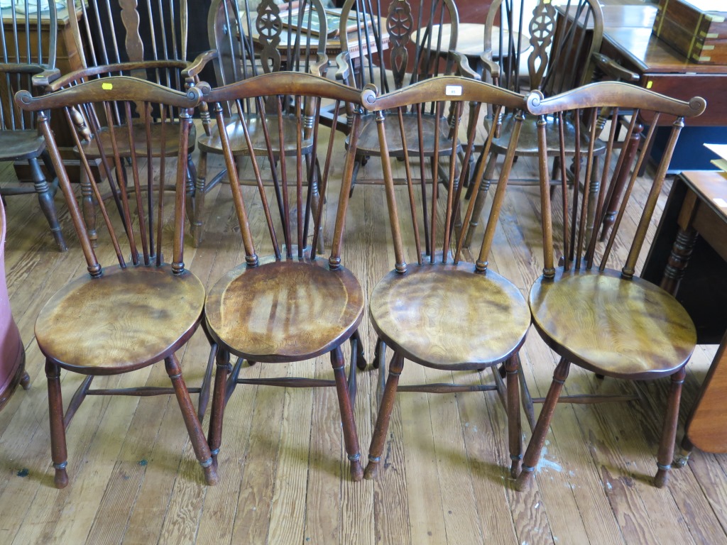 A set of four late Victorian Liberty style beech and elm dining chairs, with scroll top rails and