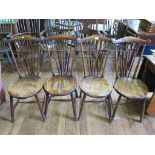 A set of four late Victorian Liberty style beech and elm dining chairs, with scroll top rails and