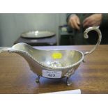 A silver plated gravy boat together with a plated ladle