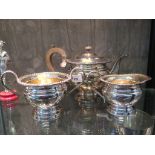 A three piece silver plated tea set with rope twist decoration and gilding to interior of milk jug