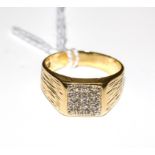 A gentleman's pinky ring with nine white stones within a square set in 18 carat gold