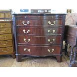A George III style serpentine chest, with brush slide and four graduated drawers flanked by blind