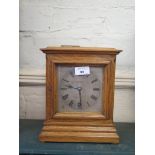 An oak cased mantel clock, retailed by Edward & Sons of London and Glasgow, with silvered dial and