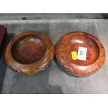 A pair of walnut wine coasters with white metal decorative designs
