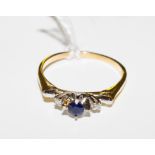 A sapphire and diamond three stone ring set in 18 carat yellow gold