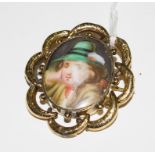 A porcelain miniature of a young boy set in a gold colour frame