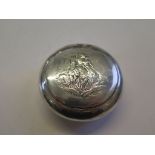 A silver round tobacco box having pressure opening, as found