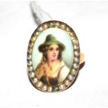 A gold colour metal ring, set with a porcelain plaque of a young man, in a seed pearl frame (one