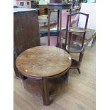 A 1920s oak coffee table, with quartered nest of four tables below, 59cm diameter, a torchere