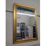 A gilt framed rectangular wall mirror, 90cm x 64cm