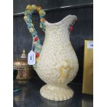 A Clarice Cliff jug, Celtic Harvest pattern with fruit handle 28cm high