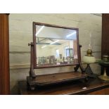 A Regency mahogany toilet mirror, with beaded platform base and ball feet, 66cm wide, 61cm high