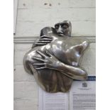 A silver effect resin wall sculpture of a couple embracing, inscribed 'From this day forward you