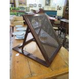 An Edwardian mahogany and wicker folding portable back rest, 54cm x 46cm, open height 50cm