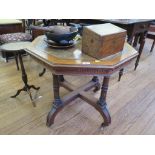 An Edwardian walnut octagonal centre table, with leather inset top on fluted turned supports with