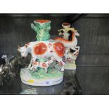 Two Victorian Staffordshire spill vase figure groups, one depicting a cow with her calf, the other a