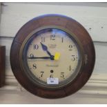 An oak framed circular Smiths Astral wall clock, inscribed J. Smith Clerkenwell, single train