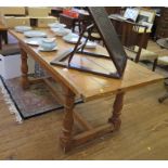 A pine refectory table, the rectangular top on turned legs joined by a H-stretcher 182cm x 75cm