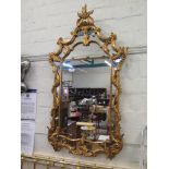 A George III style giltwood wall mirror, with foliate sprays and C- Scrolls 120cm x 66cm