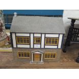 A doll's house, in timber frame and stone style, 65.5cm wide 62cm high