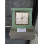 A Cyma Amic green leather table clock, Sonomatic, in green leather case and original box, 8.5cm