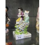 An early 19th century Staffordshire Pearlware group of couple with a dog and pipes, the base stamped