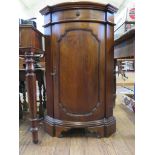 A French style walnut corner cupboard with frieze drawer over a panelled door on bracket feet,