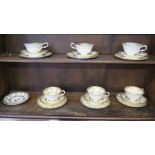 A set of six Paragon china tea cups, saucers and plates, with gilded borders and polychrome floral