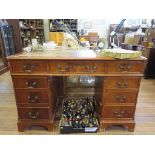 A reproduction mahogany pedestal desk, with leather inset top, filing drawer and seven other
